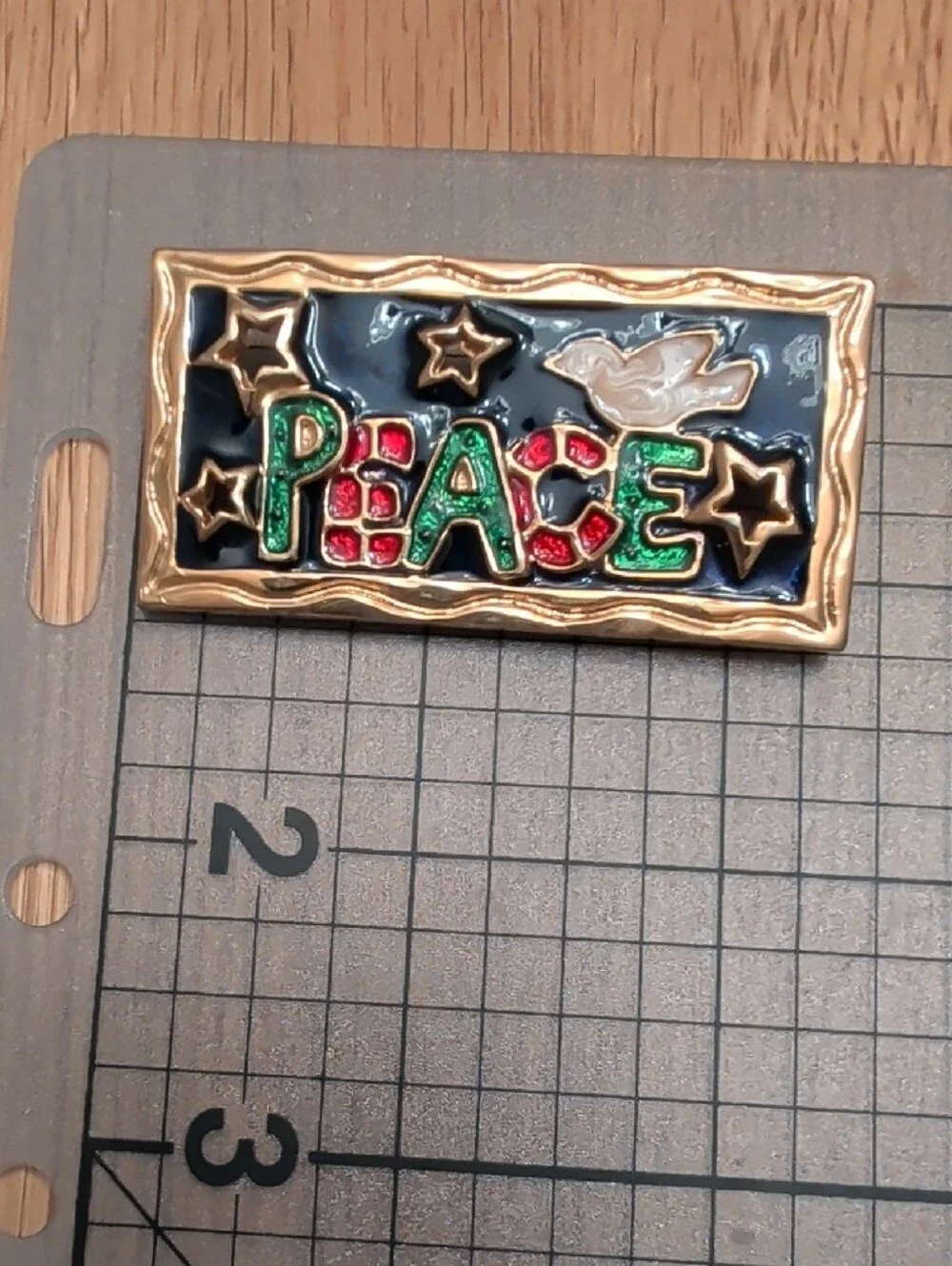Gold-Trim 'PEACE' Brooch with Green and Red Accents